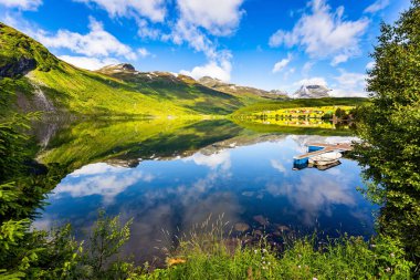 The lovely clean and calm lake Eidsvatnet. Warm sunny day in July. Summer trip to Norway. Northern Europe. 