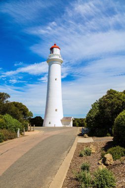 Magnificent lighthouse on the ocean shore. The Great Ocean Road runs along the Pacific coast of Australia. Considered the most scenic road in the world. 