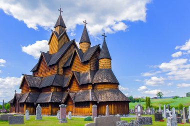 The Stave Church in Heddal was built 800 years ago. Travel to Norway in July. Cold summer in Norway. Ancient cemetery in the churchyard