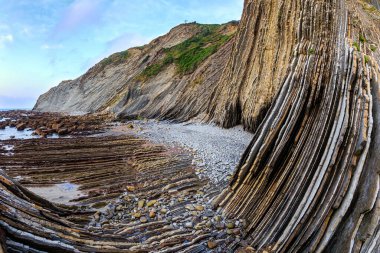 Playa Zumaya. Flysch - unique landscape of underwater rocks exposed at low tide. The most stunning beach in the Basque Country - Itsurun. Coast of the Bay of Biscay, Atlantic. 