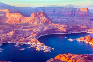 Landscape under the wing of an airplane. The coast of Lake Powell is cut by narrow canyons.  U.S. Grandiose huge lake of artificial origin among the picturesque red sandstone cliffs.  clipart