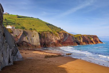 Low tide in the Atlantic. Playa Zumaya. The Basque Country - Itsurun. Incredibly bizarre coastal cliffs. Early sunny morning. clipart