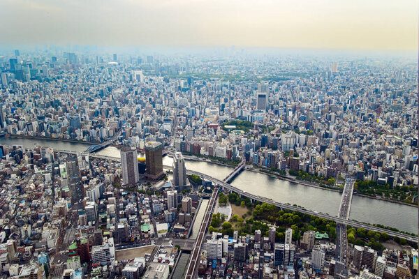 Tokyo is covered in smog. The view from the observation deck of the tower. The longest river in Tokyo is Sumida-gawa. 