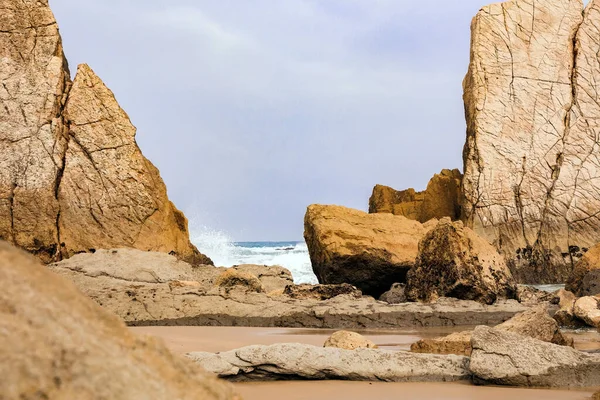 stock image  Interesting original rock ledges on the Playa de la Arnia beach. Cantabria, Spain. Amazing geological formations amaze tourists. Storm waves break on the coastal rocks. 