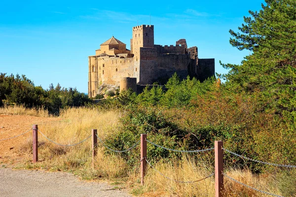 Loarre castle. The magnificent building on the top of the hill is picturesquely lit by the morning sun. Autumn trip to Spain. The province of Aragon.