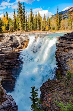 Different rocks created the layered structure of the rocks and canyon. Jasper Park. Canadian Rockies. Athabasca Falls is the most powerful waterfall in Alberta. clipart