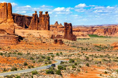The brightest and most picturesque park of the Arches. USA. The asphalt road passes through the most interesting majestic compositions. Three gossips. Sheep Rock.  clipart