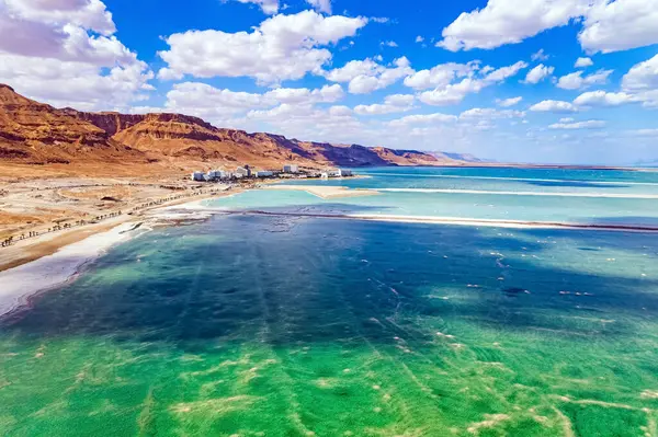 stock image The Dead Sea. Cloud shadows reflected in the water. The evaporated salt is collected on the water. Resort for relaxation and treatment. Israel. Drone filming.