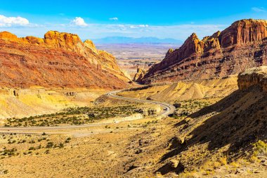 The San Rafael Reef is an enormous sandstone ridge east of Salt Lake City. The American highway. Majestic red-brown landscapes are intersected by narrow multi-colored canyons.  clipart