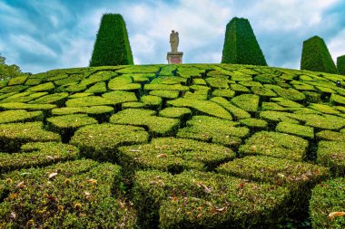 Graceful bosquets. In the  Valley is located the possession of Puss in Boots - Breteuil Castle. Beautiful park surrounds the ancient castle of Breteuil. France  clipart