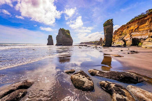 Low tide exposed the coastal strip of the ocean. The Tongaporutu beach on the Pacific coast. North Island. New Zealand. Coastal cliffs. 