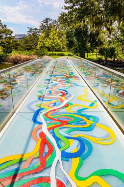 Beautiful bridge with mirrored sides across the lake. Centenary oak trees grow on the shores of the lake. New Orleans. USA. The magnificent City Park. 