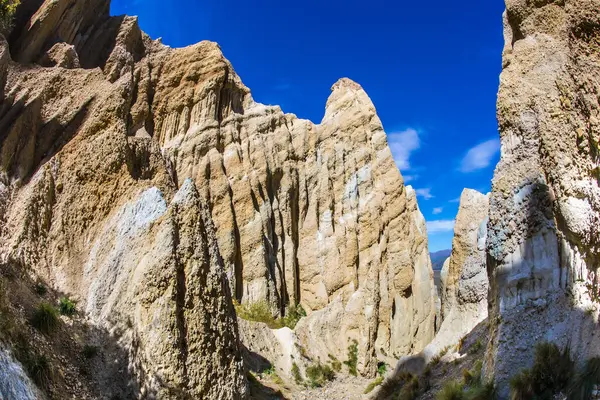 Yeni Zelanda 'nın zirveleri, Omarama Clay Kayalıkları. Clay Cliffs 'in üstündeki mavi gökyüzü. Topraktan, kumdan ve çakıldan oluşan görkemli kayalar.. 