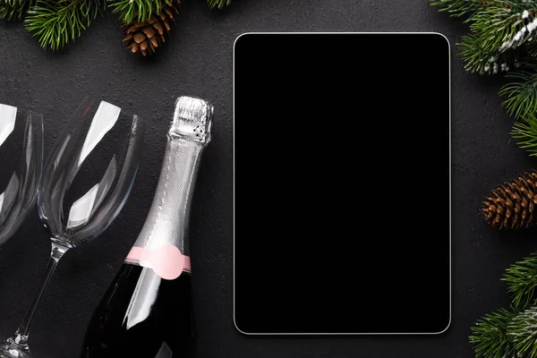 Tablet with blank screen, champagne and Christmas decor. Xmas device screen template