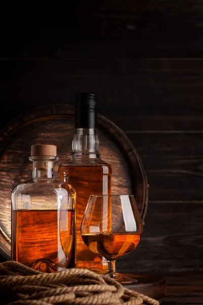 Glass Bottles Cognac Whiskey Golden Rum Front Old Wooden Barrel — Stock Photo, Image