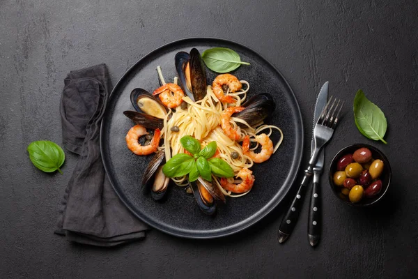 Seafood pasta with shrimps and mussels. Top view flat lay