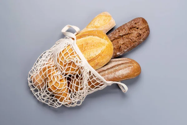 Pão Fresco Assado Saco Malha Sobre Fundo Cinza Flat Lay — Fotografia de Stock