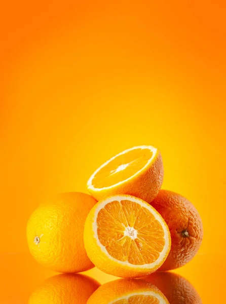 Fresh orange fruits over orange background with copy space