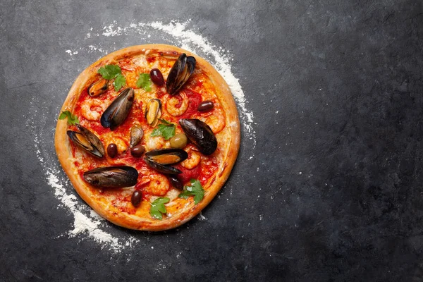 Italian cuisine. Seafood pizza. Flat lay on stone table with copy space