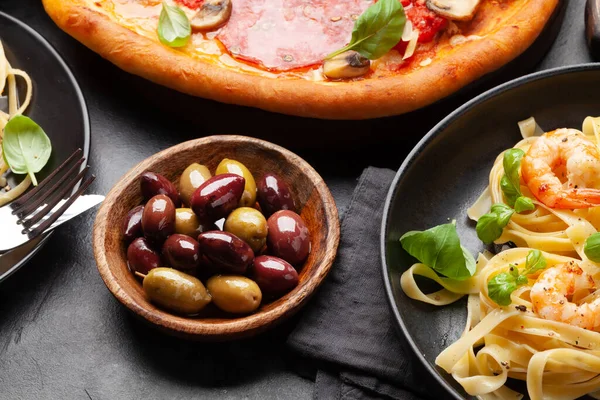 Italian cuisine. Pasta, pizza, olives and antipasto