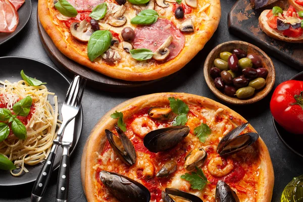 Italian cuisine. Pasta, pizza, olives and antipasto toasts