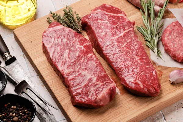 stock image Prime marbled beef steaks and spices. Raw striploin steak