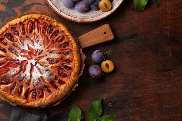 Homemade plum pie. Fruit tart with seasonal fruits. Flat lay with copy space