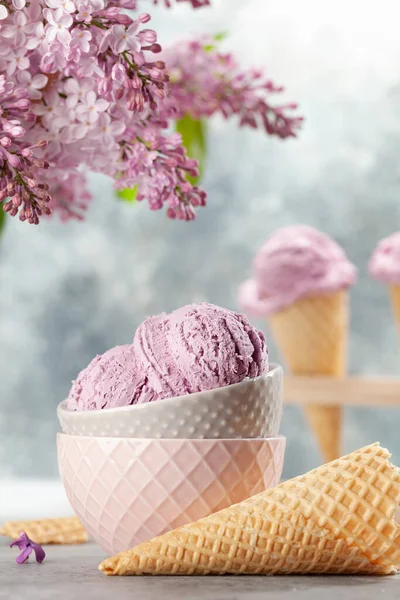 ボウルにアイスクリームのサンデー ワッフルコーンとライラックの花 — ストック写真