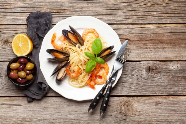 Seafood pasta with shrimps and mussels. Top view flat lay with copy space