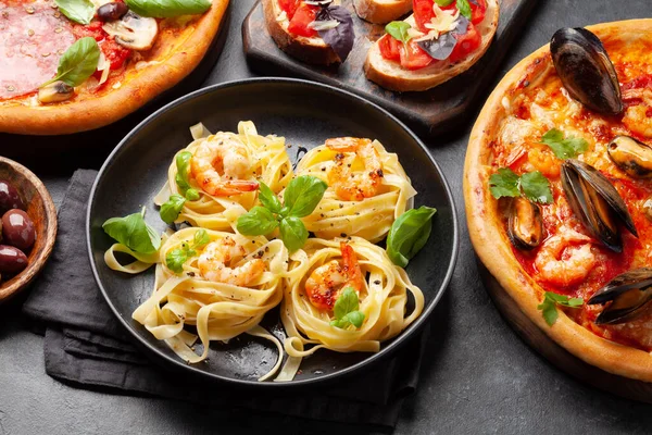 Italian cuisine. Pasta, pizza, olives and antipasto toasts