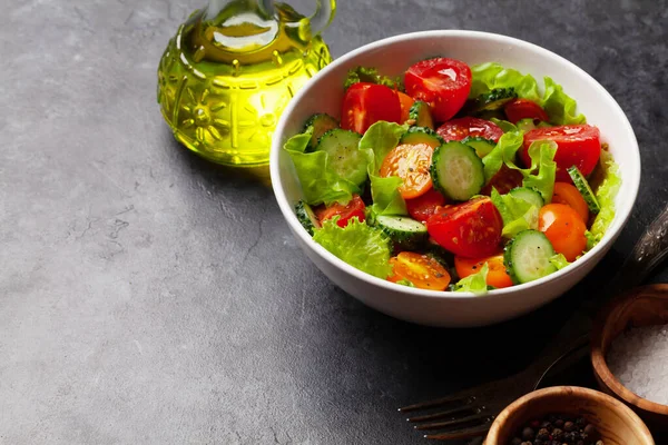 Fresh salad with garden tomato and cucumber. With copy space