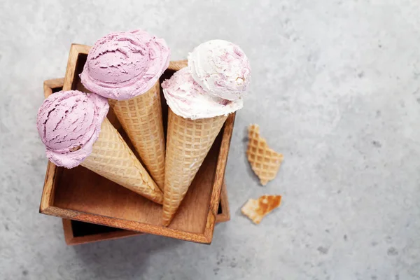 Berry ice cream sundae in waffle cones. Flat lay with copy space