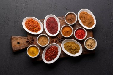 Tahtadaki küçük kaselerde çeşitli kurutulmuş baharatlar.