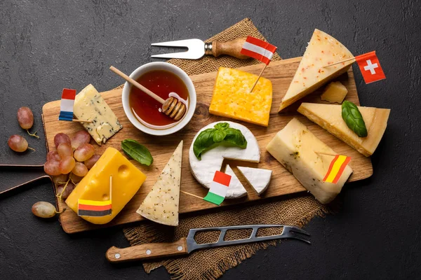 Various cheese with different Europe flags on board. Flat lay