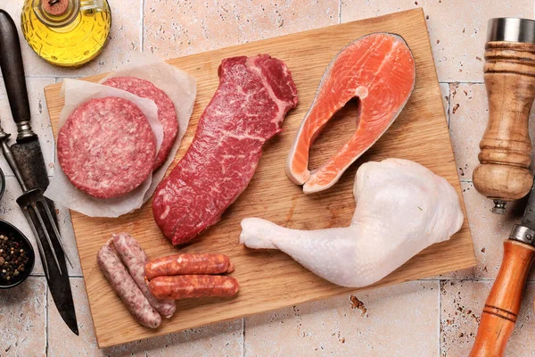 Various raw meat and fish. Steaks, sausages, salmon, chicken and spices. Flat lay