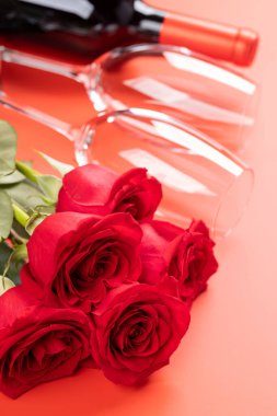Valentines day card with champagne glasses and rose flowers. On red background