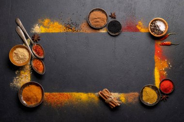 Various spices on stone table. Frame with copy space for your menu or recipe