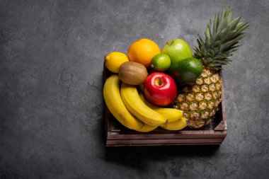 Wooden box full of healthy fruits food. With copy space