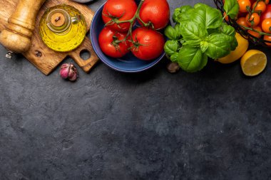 Ingredients for cooking. Italian cuisine. Tomatoes, basil and spices. Flat lay with copy space
