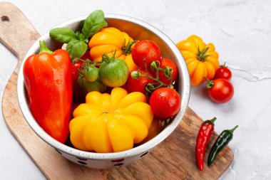 Various colorful garden tomatoes and bell peppers. Fresh vegetables and spices