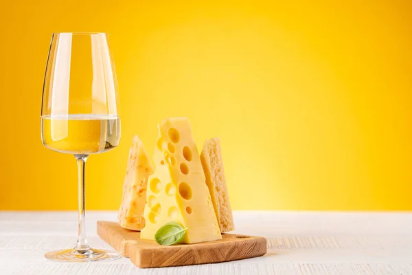 Berbagai Keju Papan Dan Anggur Putih Latar Belakang Kuning Dengan — Stok Foto