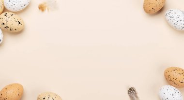 Easter eggs on a beige background with space for your greetings. Flat lay