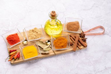 Taş masadaki küçük kaselerde çeşitli kurutulmuş baharatlar.
