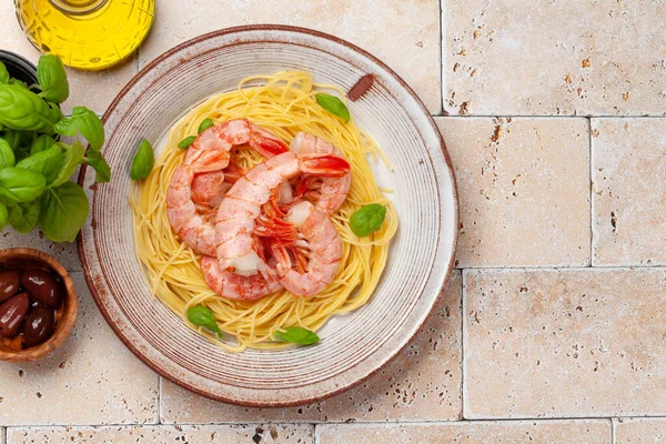 Pasta with shrimps. Italian cuisine. Flat lay with copy space
