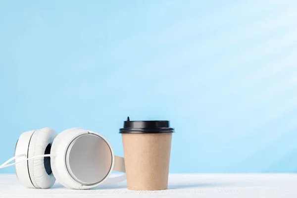 White Headphones Coffee Cup Blue Background Copy Space — стоковое фото