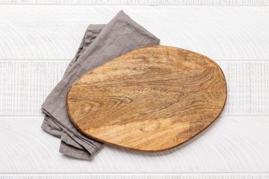 Wooden cutting board and kitchen towel. Flat lay with copy space