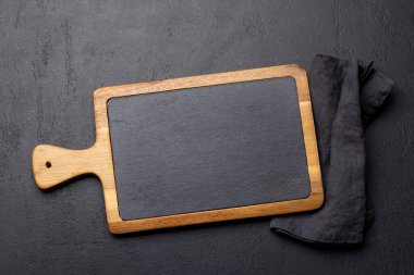 Wooden cutting board and kitchen towel. Flat lay with copy space