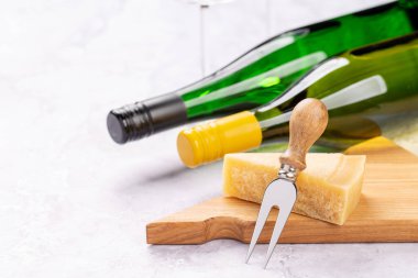 Cheese on board and white wine. With copy space