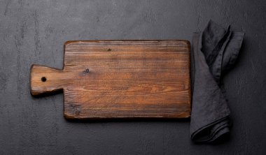 Wooden cutting board and kitchen towel. Flat lay with copy space