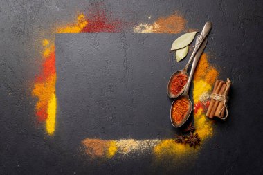 Various spices on stone table. Frame with copy space for your menu or recipe